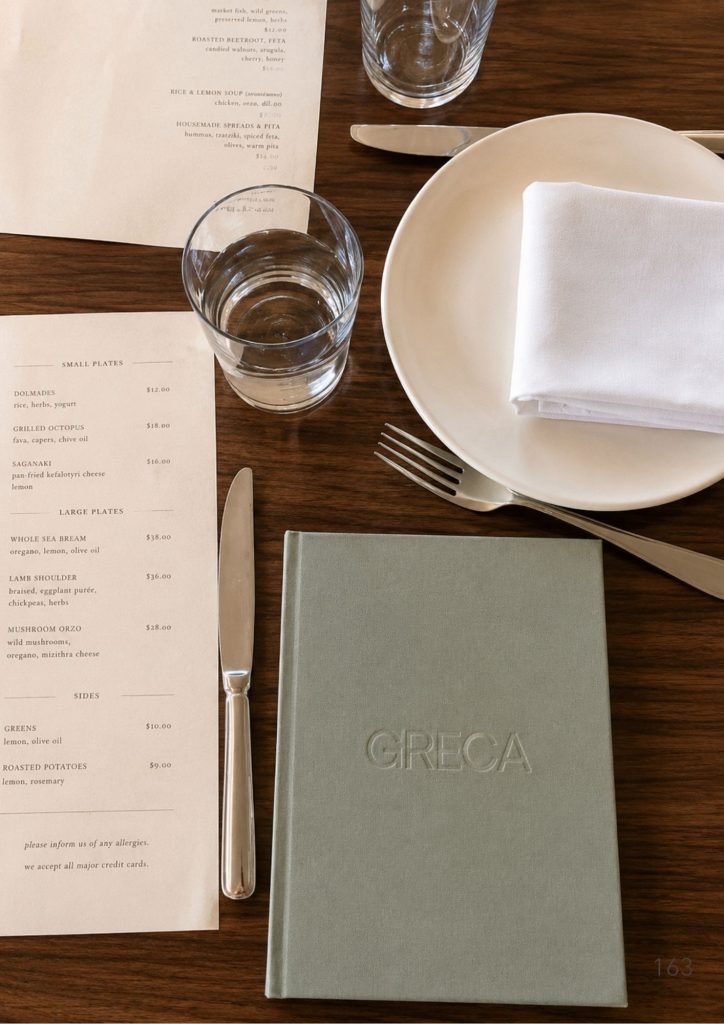 The menu and a set table at Greca on the Brisbane riverfront