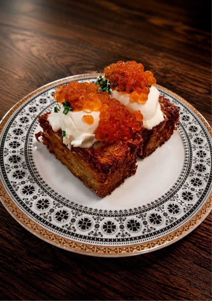 A potato rosti with sour cream and salmon roe at one of the best restaurants in Brisbane