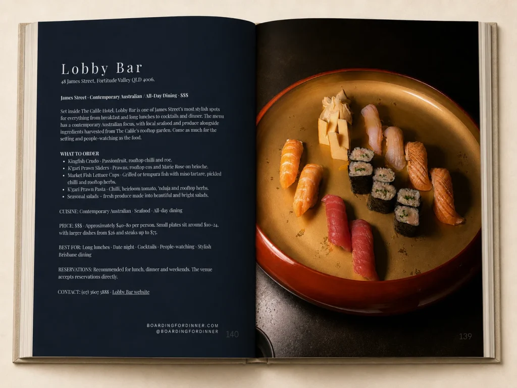 Open Brisbane Food Guide page on a lobby bar beside a plate of sushi