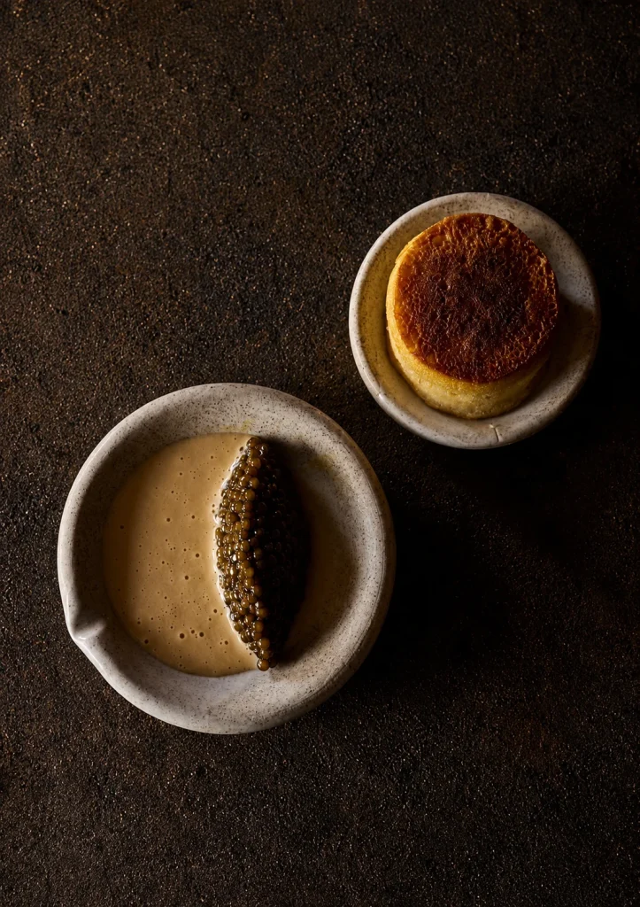 An espresso and creme brulee on a dark table at a Byron Bay cafe